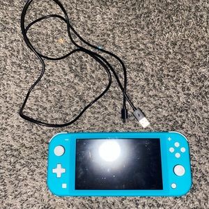 Nintendo switch lite in turquoise with games